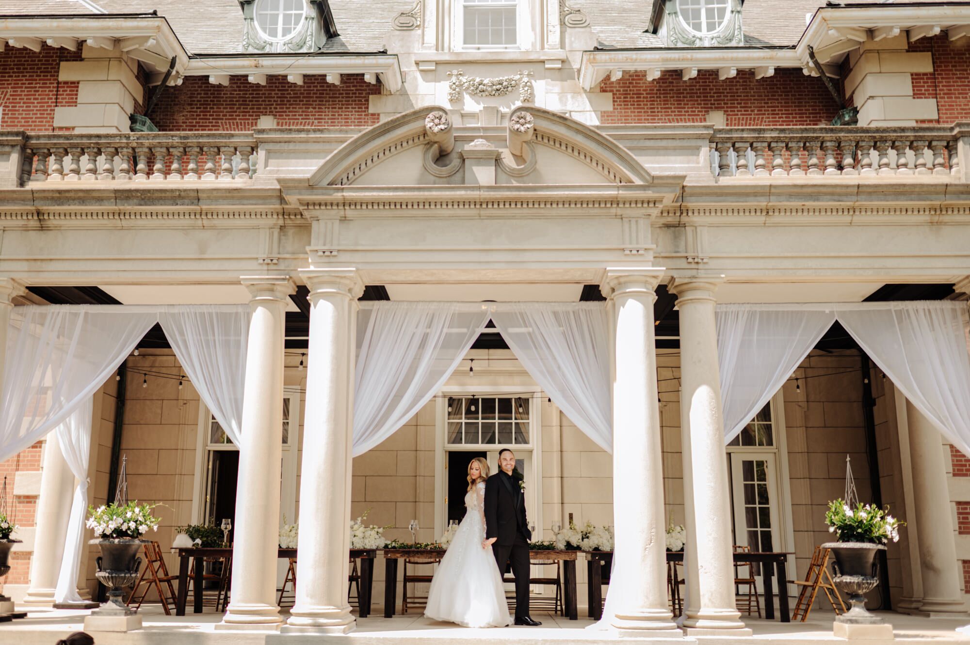 Bride and groom take a moment to themselves on the porch of Gardencourt on Presbyterian Campus in Louisville Kentucky