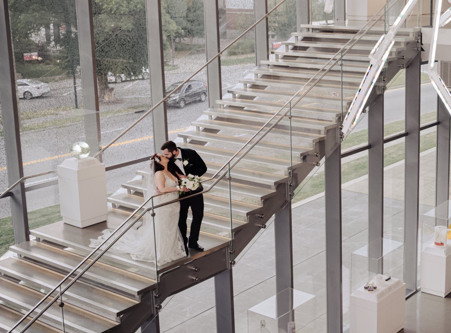bride and groom snuggle on the steps of the Speed Art Museum