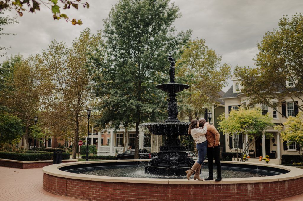 Couple kisses atop a vintage fountain in Norton Commons, Louisville, Kentucky