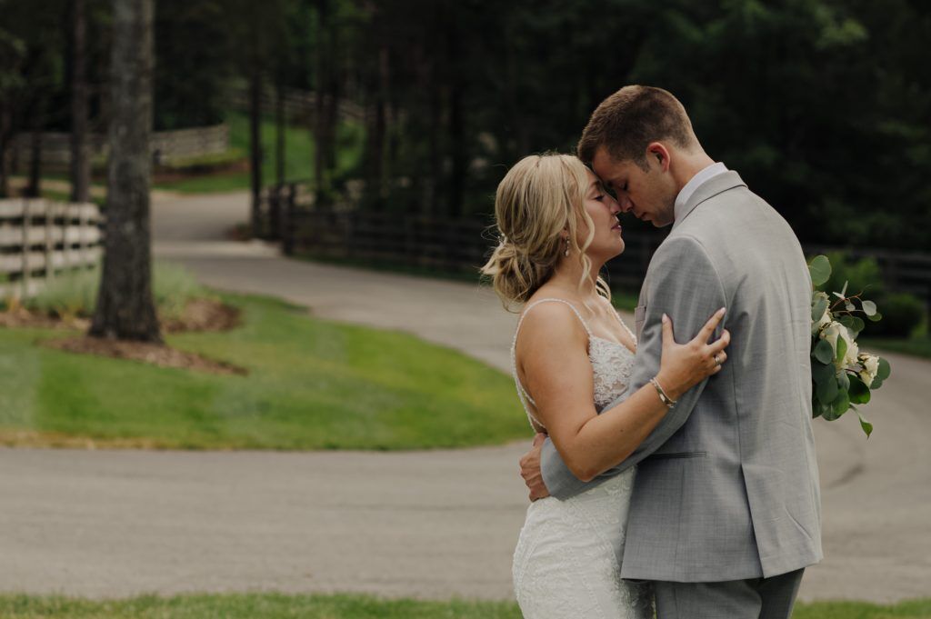 Snuggling outside of the Woods at Cedar Springs together before bride and groom get married