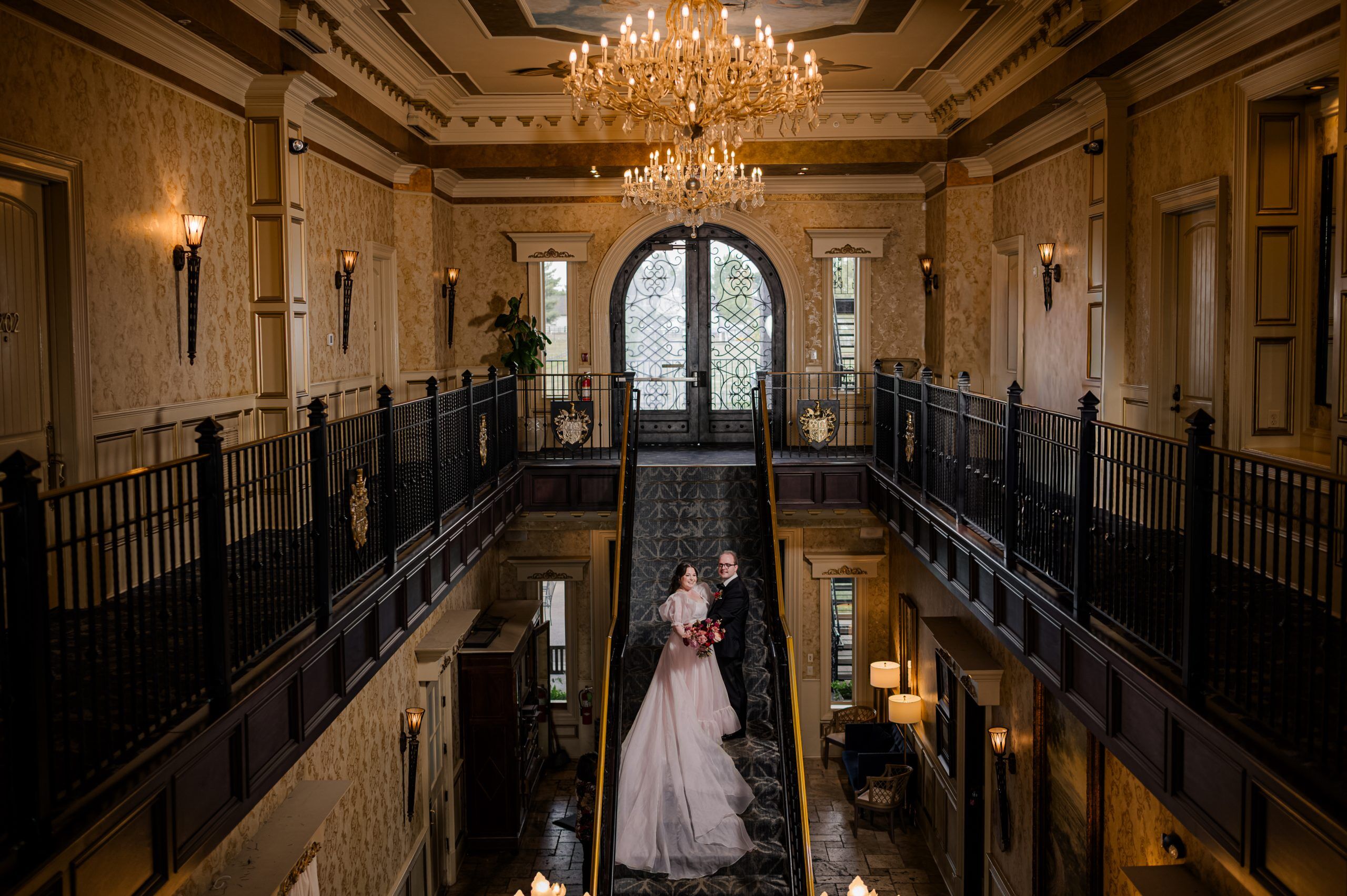 The iconic staircase at the Kentucky Castle with a bride and groom