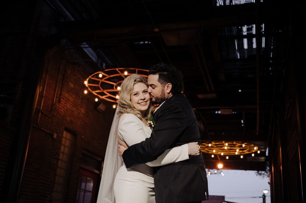 wedding couple snuggle at Mellwood for videographer