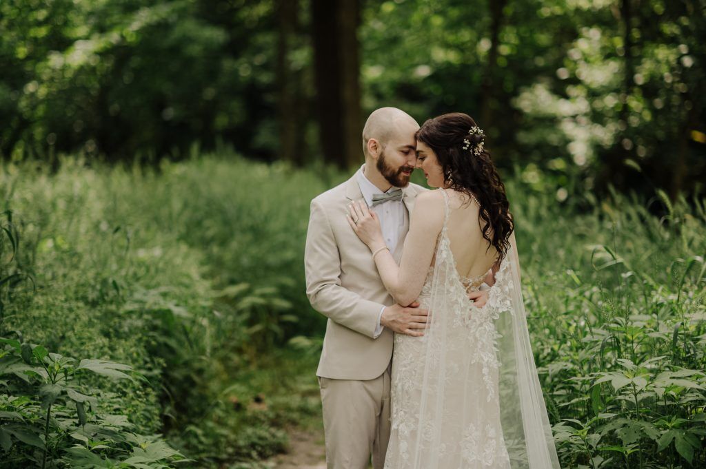 couple snuggles while eloping in Michigan 