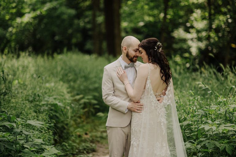 couple snuggles while eloping in Michigan