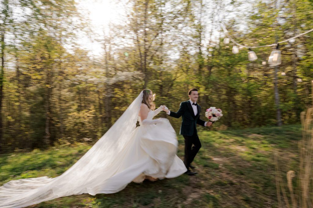 couple runs through field together - blurry - Green Apple Photography